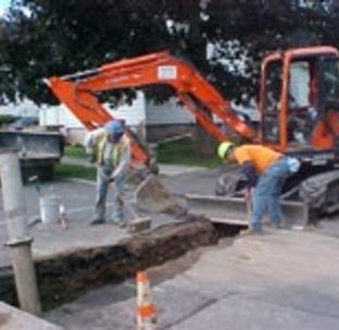 Workers with sewer machinery