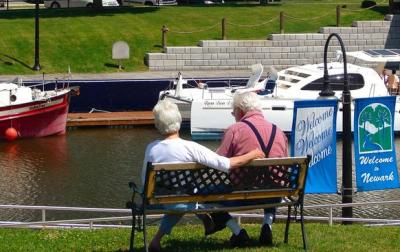Couple sitting on bench overlooking canal